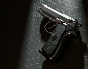 Handgun laying on metal surface